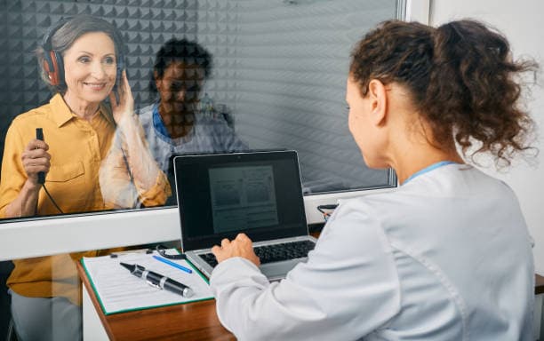 Audiologist conducting hearing test
